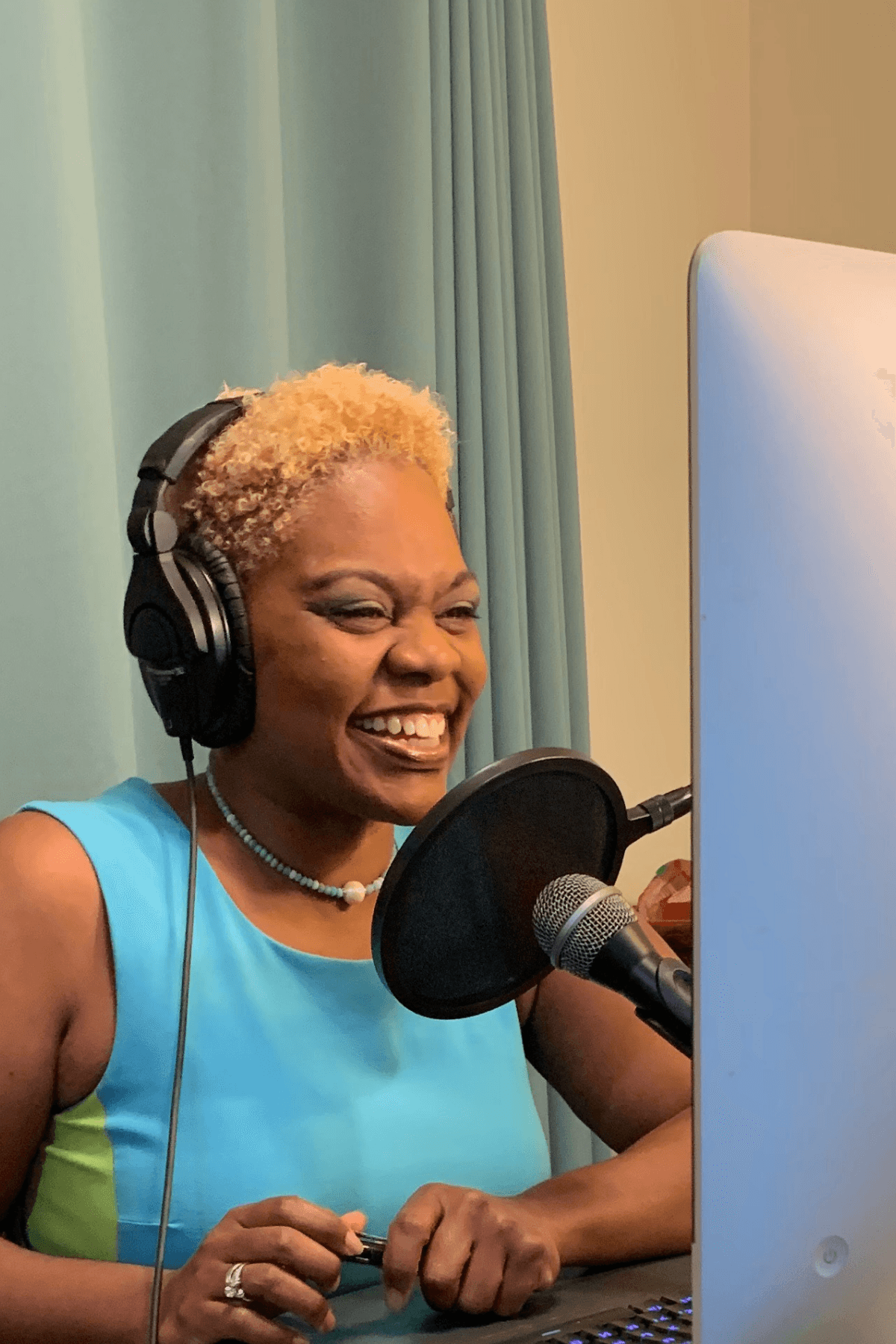 Dr. LaKeischa recording Hormone Hottie Hotline, headphones, mic, in-studio